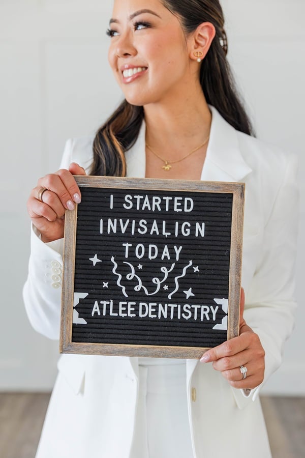 Dr. Alice holding an "I Started Invisalign Today" letter-board sign