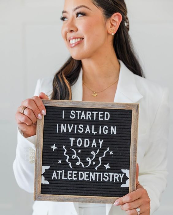 Dr. Alice holding an "I Started Invisalign Today" letter-board sign